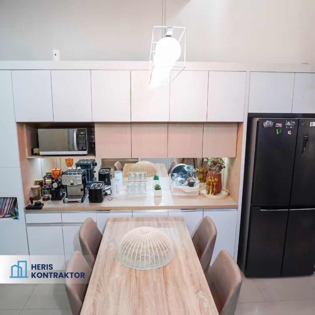 Dapur minimalis dengan peralatan dapur lengkap, meja kayu, dan kursi nyaman, desain modern dan rapi.