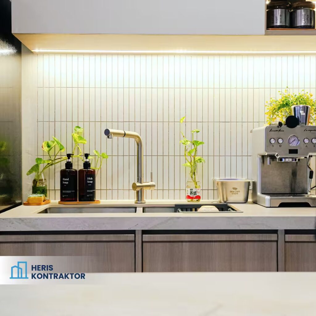 Area sink dapur minimalis dengan tanaman hias dan peralatan kopi stainless steel.